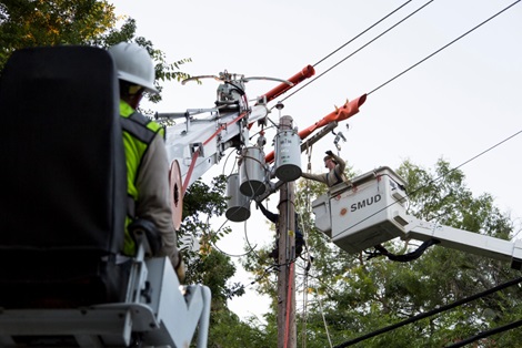 SMUD lineworkers working on a power pole