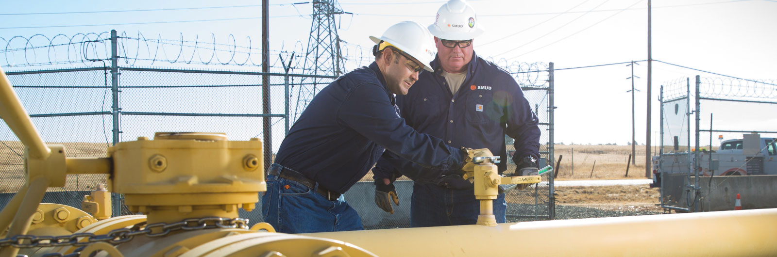 Two employees work on gas pipeline