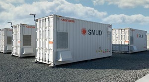 Utility-scale batteries, looking like storage containers, with SMUD printed on the side