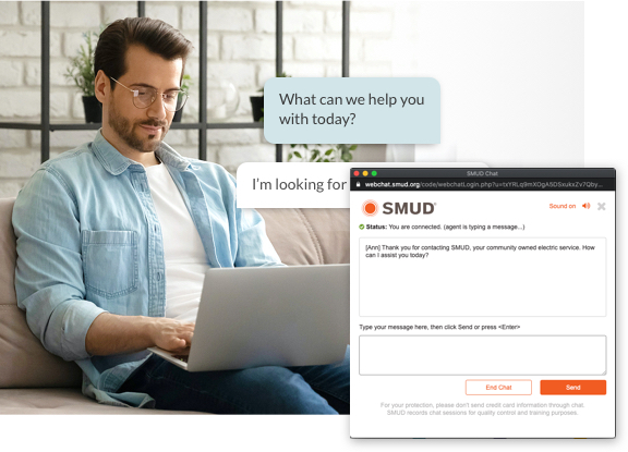 Man sitting on couch with laptop using SMUD live chat