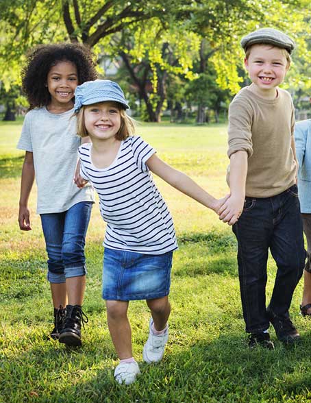 Children in a park holding hands